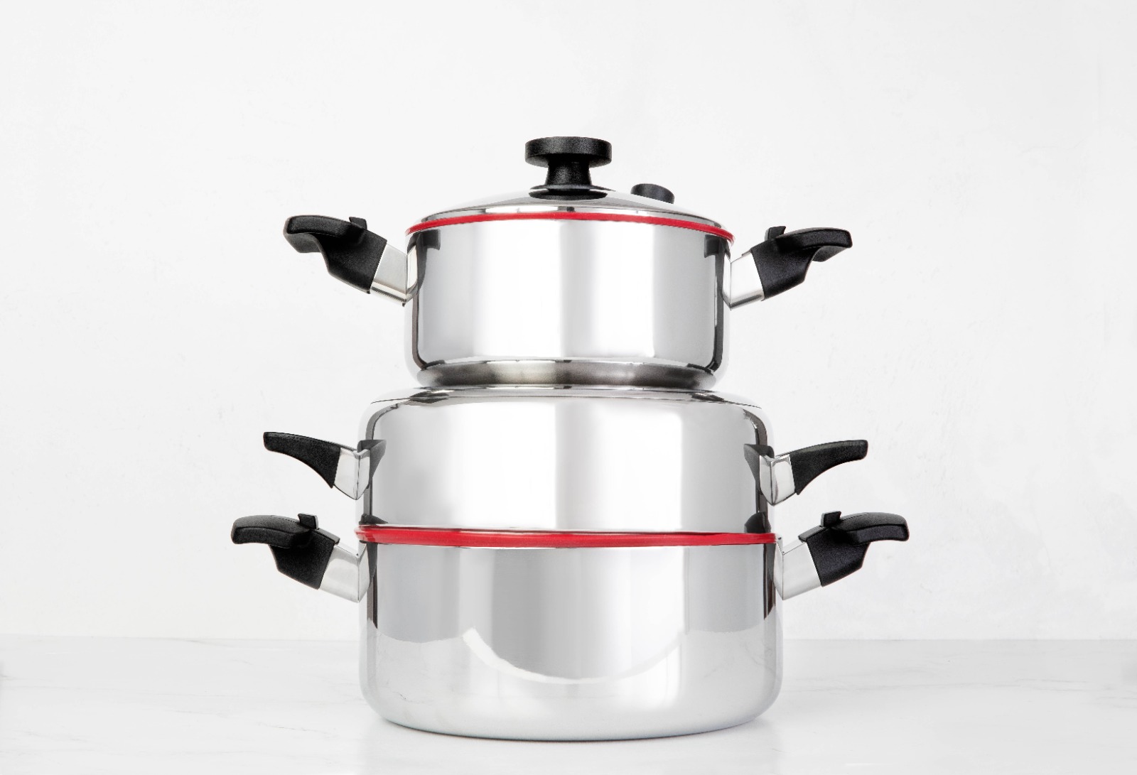 A close-up shot of Royal Prestige cookware displayed on a countertop, highlighting its sleek, polished design and high-quality materials. The image should convey a sense of durability, longevity, and timeless elegance.